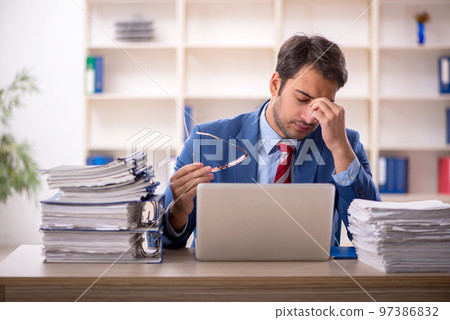 Young male employee working in the office Young male employee working in the office 97386832