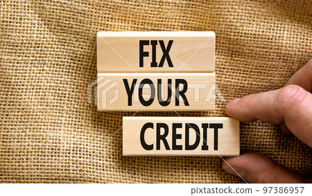 Fix your credit symbol. Concept words Fix your credit on wooden blocks on a beautiful canvas table canvas background. Businessman hand. Business, finacial and fix your credit concept. Copy space. Fix your credit symbol. Concept words Fix your credit on wooden blocks on a beautiful canvas table canvas background. Businessman hand. Business, finacial and fix your credit concept. Copy space. 97386957