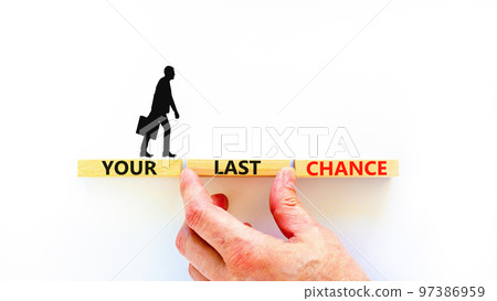 Time to your last chance symbol. Concept words Your last chance on wooden blocks on a beautiful white table white background. Businessman hand. Business and your last chance concept. Copy space. Time to your last chance symbol. Concept words Your last chance on wooden blocks on a beautiful white table white background. Businessman hand. Business and your last chance concept. Copy space. 97386959