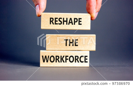 Reshape the workforce and support symbol. Concept words Reshape the workforce on wooden blocks. Businessman hand. Beautiful grey background. Business reshape the workforce quote concept. Copy space Reshape the workforce and support symbol. Concept words Reshape the workforce on wooden blocks. Businessman hand. Beautiful grey background. Business reshape the workforce quote concept. Copy space 97386970