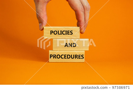 Policies and procedures symbol. Wooden blocks with words 'Policies and procedures' on orange background. Businessman hand. Business, policies and procedures concept. Copy space. Policies and procedures symbol. Wooden blocks with words 'Policies and procedures' on orange background. Businessman hand. Business, policies and procedures concept. Copy space. 97386971