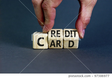 Credit card symbol. Concept words Credit card on wooden cubes. Businessman hand. Beautiful grey table grey background. Credit card and business concept. Copy space. Credit card symbol. Concept words Credit card on wooden cubes. Businessman hand. Beautiful grey table grey background. Credit card and business concept. Copy space. 97386977