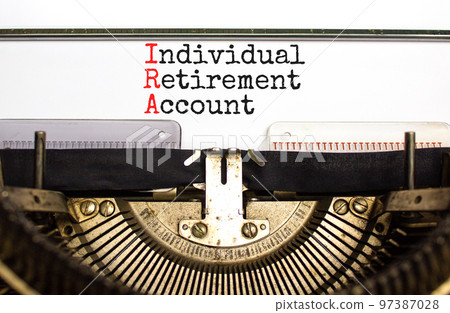 IRA individual retirement account symbol. Concept words IRA individual retirement account typed on retro typewriter. White background. Business IRA individual retirement account concept. Copy space 97387028