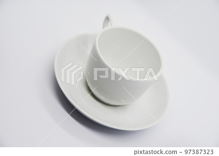 Tea couple on a white background. Porcelain service close-up. A teacup and saucer. Tea couple on a white background. Porcelain service close-up. A teacup and saucer. 97387323