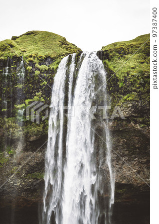 Seljalandsfoss waterfall, Gljufrabui Iceland - vertical drone photo 97387400