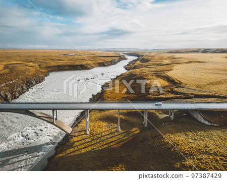 Bridge over the river in Iceland in autumn at sunset 97387429