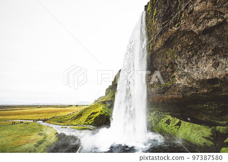 Water falling over the rock formation - Seljalandsfoss, Gljufrabui waterfall Water falling over the rock formation - Seljalandsfoss, Gljufrabui waterfall 97387580