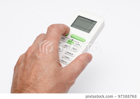 Man's hand using remote controler. Hand holding remote and adjusting temperature of air conditioner mounted on a white wall. Man's hand using remote controler. Hand holding remote and adjusting temperature of air conditioner mounted on a white wall. 97388768