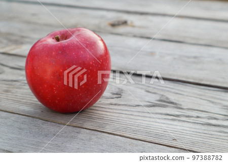 Red ripe apple on a rustic gray wooden boards. Copy space Red ripe apple on a rustic gray wooden boards. Copy space 97388782