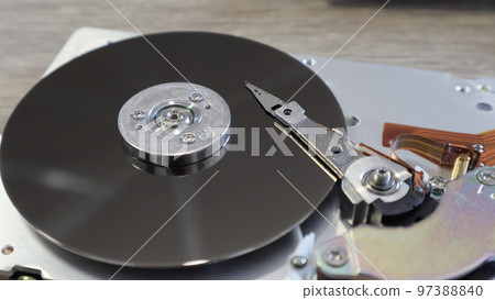 Disassembled computer hard drive. Data hard drive backup disc hdd disk restoration. Disassembled hard drive from the computer, hdd with mirror effect. Disassembled computer hard drive. Data hard drive backup disc hdd disk restoration. Disassembled hard drive from the computer, hdd with mirror effect. 97388840