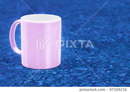 Pink ceramic cup mug on dark blue emerald spotted background Pink ceramic cup mug on dark blue emerald spotted background 97389216