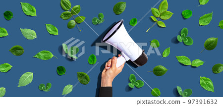 Person holding a megaphone with green leaves 97391632