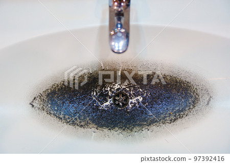 dirty sink after cleaning the clog in the pipe. 97392416