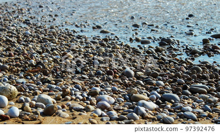 pebbles washed by the waves on the beach pebbles washed by the waves on the beach 97392476