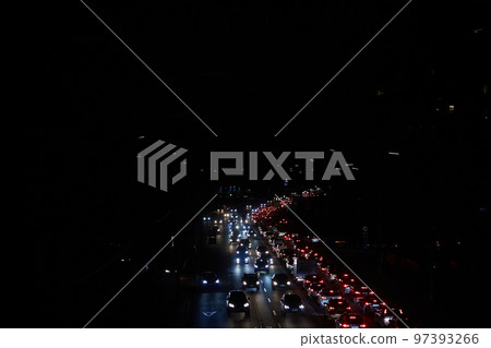 Kyiv, Ukraine - December 16, 2022: Blackout in the Ukrainian capital Kyiv. Capital streets without street lighting. Only the lights of passing cars are visible 97393266