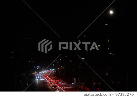 Kyiv, Ukraine - December 16, 2022: Blackout in the Ukrainian capital Kyiv. Capital streets without street lighting. Only the lights of passing cars are visible 97393270