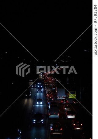Kyiv, Ukraine - December 16, 2022: Blackout in the Ukrainian capital Kyiv. Capital streets without street lighting. Only the lights of passing cars are visible 97393284