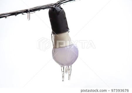 icicles on frozen street lighting lamps. winter weather season icicles on frozen street lighting lamps. winter weather season 97393676