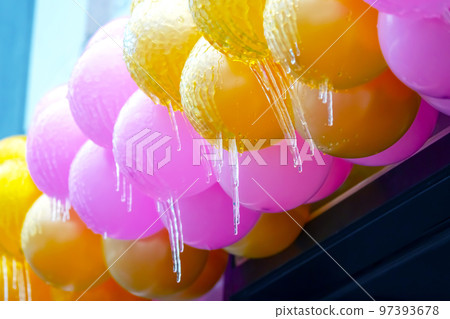 icicles on frozen colored inflatable holiday balls. winter weather season. street interior details icicles on frozen colored inflatable holiday balls. winter weather season. street interior details 97393678