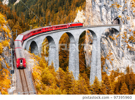 Bernina express glacier train on Landwasser Viaduct in autumn, Switzerland 97395960
