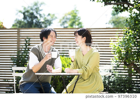 Young couple drinking coffee on the terrace 97396310