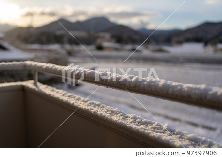 Balustrade on the snow-covered veranda 97397906