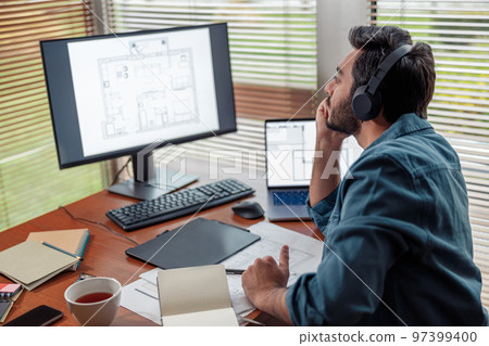 indian male designer in headphones works in home office drawing on graphic tablet indian male designer in headphones works in home office drawing on graphic tablet 97399400