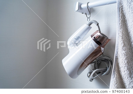 Hair dryer and towels hanging from the handrail of the washroom 97400143