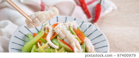 Stir-fried neritic squid with celery. Delicious homemade seafood with vegetable meal. 97400979
