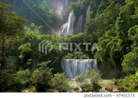 beautiful waterfall in green forest beautiful waterfall in green forest 97401573