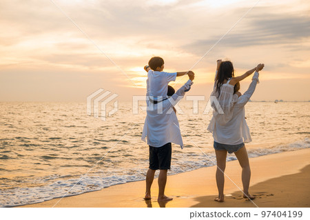 Happy family in holiday. Father, Mother and kids having fun together shoulder ride on summer beach, Parents carrying children on shoulders at beach on sunset time, Family on holiday summer vacation Happy family in holiday. Father, Mother and kids having fun together shoulder ride on summer beach, Parents carrying children on shoulders at beach on sunset time, Family on holiday summer vacation 97404199