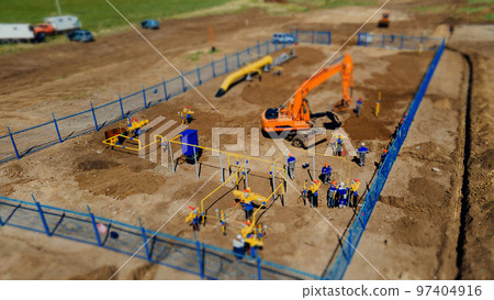 Aerial view excavator and construction workers working on construction site in open field. Pipe 97404916