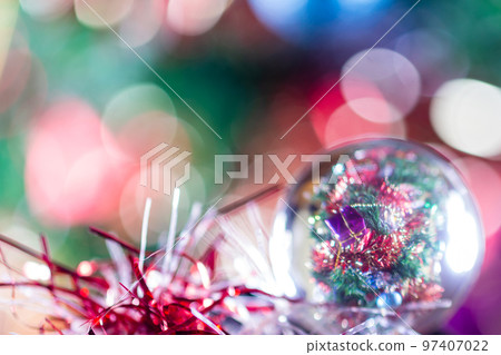 Close-up of Christmas decorations on a tree through lensball sphere 97407022