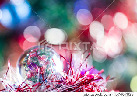 Close-up of Christmas decorations on a tree through lensball sphere 97407023