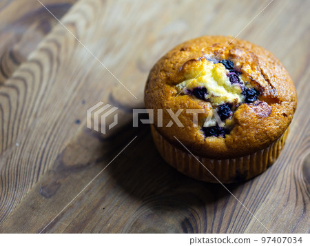 Blueberry muffin on rustic wooden background Blueberry muffin on rustic wooden background 97407034