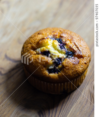Blueberry muffin on rustic wooden background Blueberry muffin on rustic wooden background 97407035