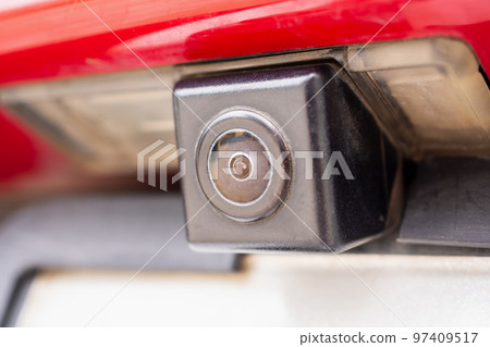 Red car rear view camera close up for parking assistance Red car rear view camera close up for parking assistance 97409517