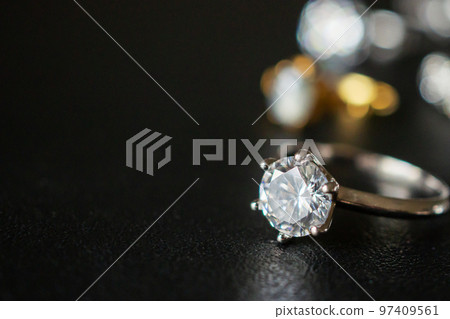 Jewelry diamond rings set on black background close up Jewelry diamond rings set on black background close up 97409561