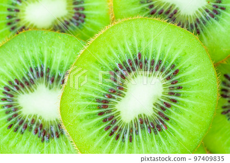 Fresh kiwi fruit slices closeup macro background Fresh kiwi fruit slices closeup macro background 97409835
