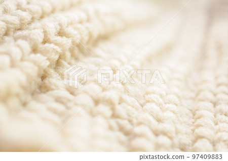 closeup beige knitted woolen fabric texture background 97409883