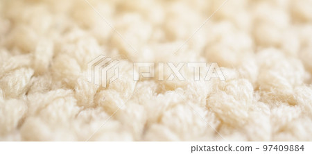 closeup beige knitted woolen fabric texture background 97409884