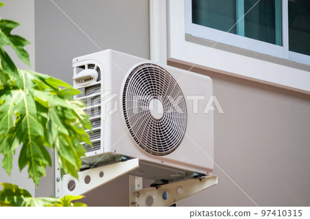 Air conditioner compressor outdoor unit installed outside the house Air conditioner compressor outdoor unit installed outside the house 97410315