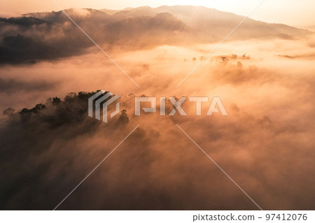 Sunrise in the forest,Aerial view of thick morning fog Sunrise in the forest,Aerial view of thick morning fog 97412076