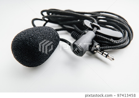 Buttonhole on a white background. Compact microphone for audio recording. Buttonhole on a white background. Compact microphone for audio recording. 97413458