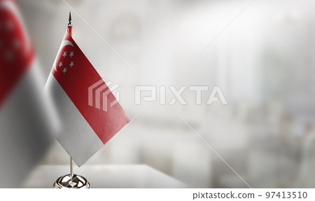 Small flags of the Singapore on an abstract blurry background 97413510