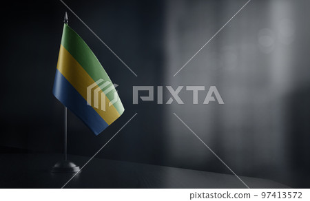 Small national flag of the Gabon on a black background 97413572