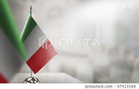 Small flags of the Italy on an abstract blurry background 97413589