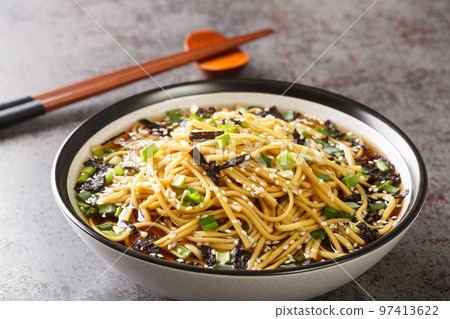 Memil guksu is a traditional Korean soba noodle soup boiled in a broth made from guksijangguk and Japanese hondashi closeup in the bowl. Horizontal Memil guksu is a traditional Korean soba noodle soup boiled in a broth made from guksijangguk and Japanese hondashi closeup in the bowl. Horizontal 97413622