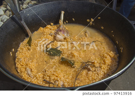 Rice in a cauldron with garlic. Pilaf. Cooking 97413916