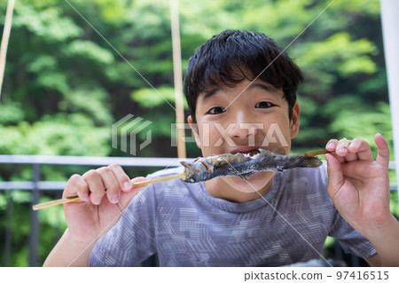 Family enjoying fishing in mountain stream 97416515